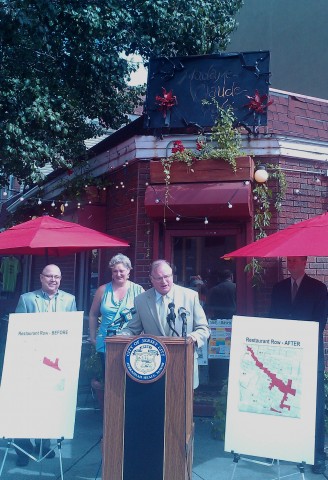 Jersey City Mayor Jerramiah T. Healy speaks during a press conference Thursday announcing the recent expansion of Restaurant Row.  (from left:  City Planning Director Robert Cotter, restaurateur Alice Troietto of Madame Claude Cafe, and Housing, Economic Development & Commerce Director Carl Czaplicki.)