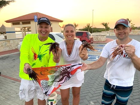 Lionfish hunters Roger Muller and Jared Casperson with Muller's wife Andrea 