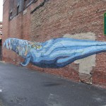 This whale is painted on a wall for a parking lot behind the Palace Drug Store on Newark Avenue in downtown Jersey City, between Bowers and Jersey Avenue.