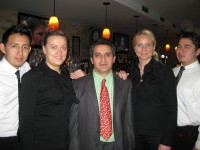 Copacabana Grill Restaurant owner Luigy Rivas (center) surrounded by his staff